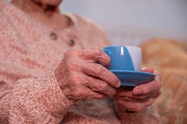 istock Old woman drinking coffee with smile on her face 1998501694