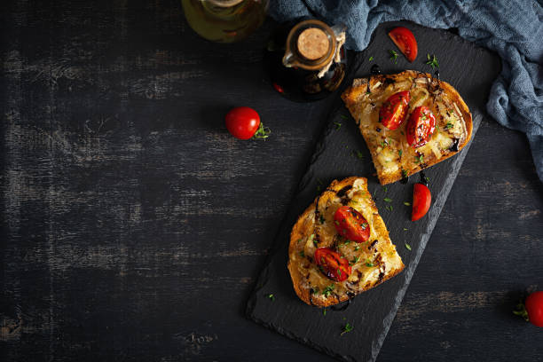 istock Hot sandwich with caramelized onion and cheese. Roasted bread toast 1998515249