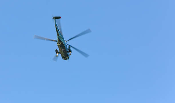 istock military helicopters flying in blue sky (air force style chopper with large blades) two copters (presidential transport over hudson river in new york city) 1998527435