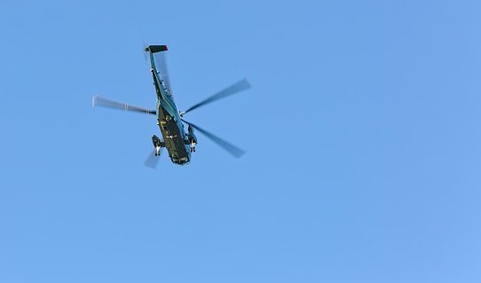 military helicopters flying in blue sky (air force style chopper with large blades) two copters (presidential transport over hudson river in new york city)
