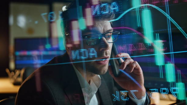 istock Successful broker speak cell in projected sales data closeup. Busy man consult 1998559661