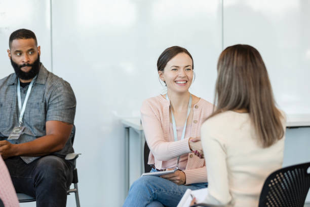 istock Businessman watches interaction between female co-workers 1998567512