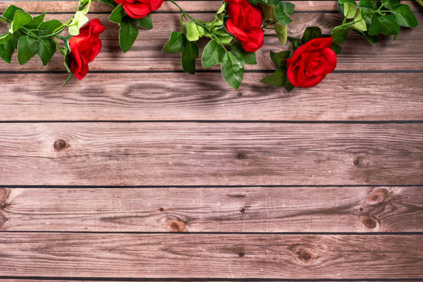 red roses on wooden background