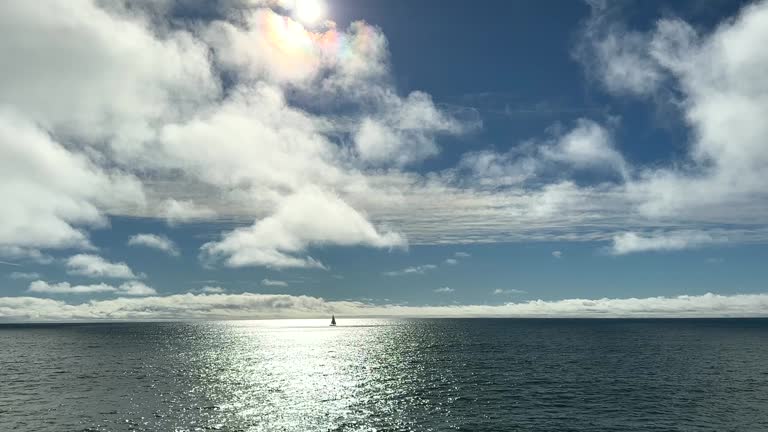 Sailboat Cruising Along The Ocean Horizon; Scenic View From The Oceanside Beach Pier In San Diego, California.