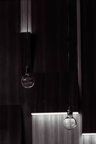 istock A round transparent electric light bulb on a dark background 1998584644