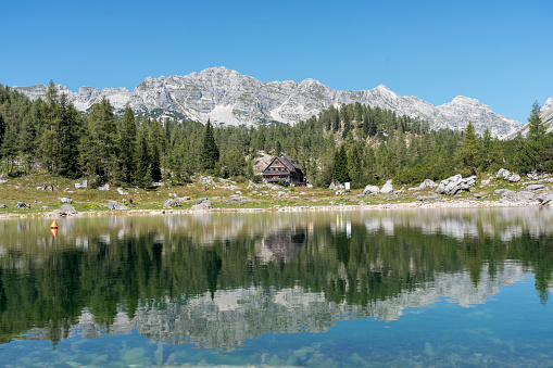 On of Seven Triglav's lakes and mountain hut on sunny day. Julian Alps, Slovenia