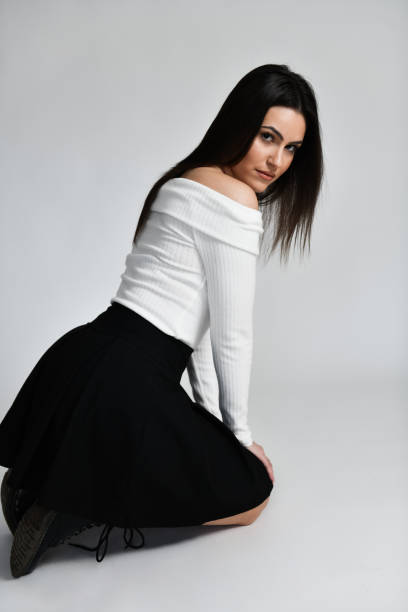 istock Cute Female Kneeling In Front Of Grey Background 1998603926