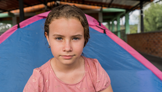 portrait of a blonde girl with a serious and ill-tempered expression on her face