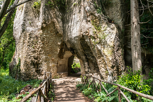 Syracuse, Italy-May 9, 2022:View of the famous and vast natural park in Syracuse with an ancient Greek theatre, a church, caves and other remains from the Roman era.