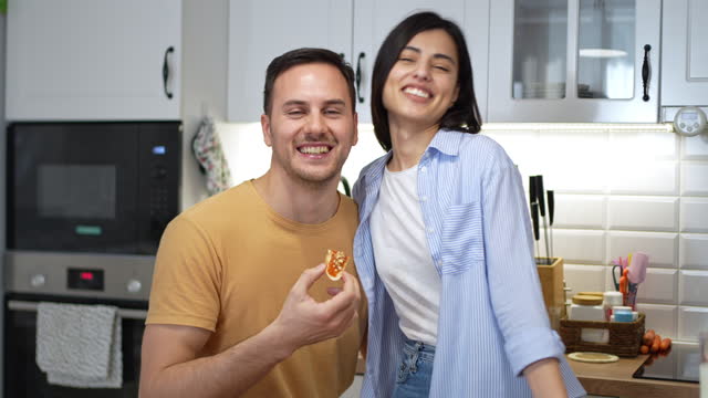 Portrait of an young Caucasian couple having breakfast in the kitchen