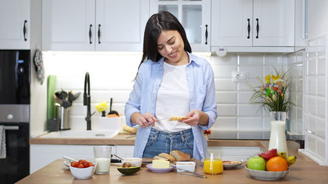Portrait of an young woman having an breakfast in the kitchen
