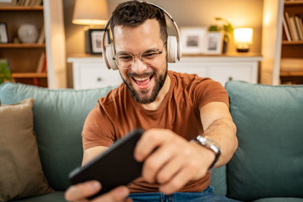 istock A man playing video games on his smartphone 1998653510