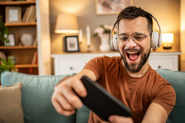 istock A man playing video games on his smartphone 1998653512