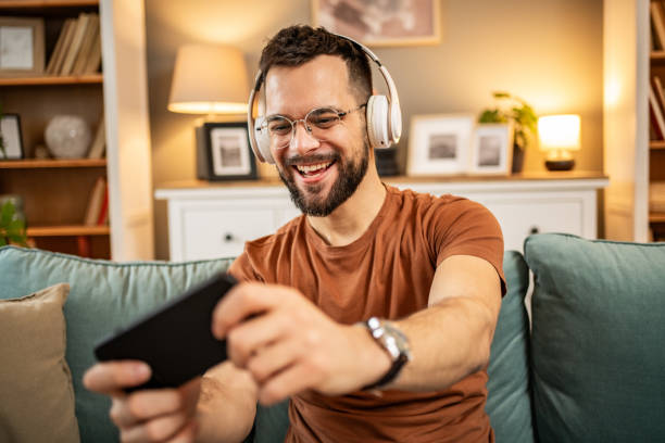 istock A man playing video games on his smartphone 1998654025