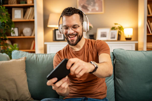istock A man playing video games on his smartphone 1998654036