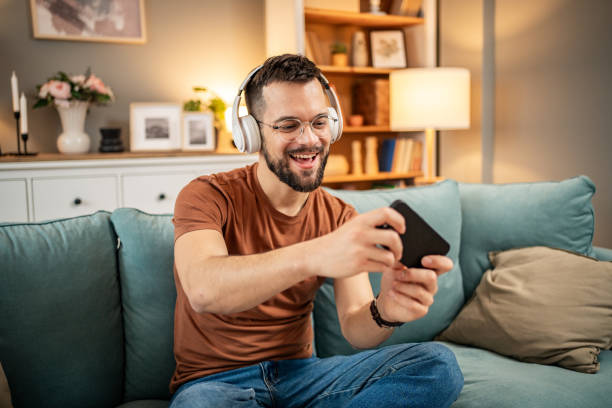istock A man playing video games on his smartphone 1998654044