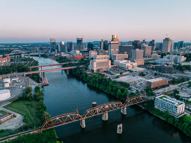 North Side Aerial View of Downtown Nashville, Tennessee on a Sunny Autumn Evening from the North Side of the Cumberland River Aerial Point of View facing South of Music City, Downtown Nashville, Tennessee from the North Side of the Cumberland River near Nissan Stadium. nashville tennessee bridge stock pictures, royalty-free photos & images