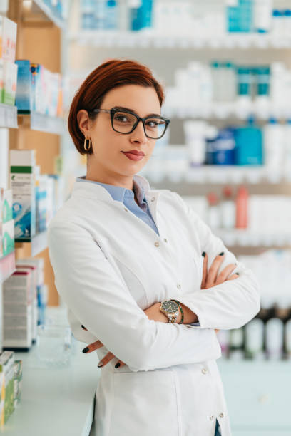 istock Beautiful female pharmacist working in a drug store. 1998664996