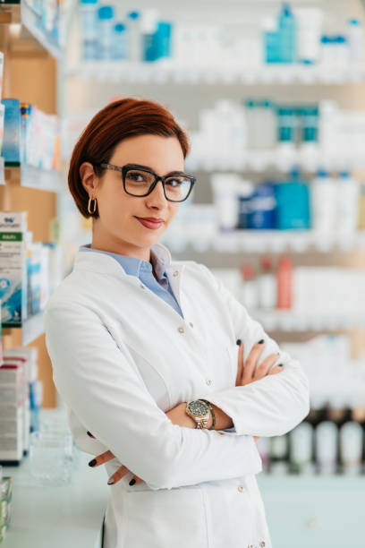 istock Beautiful female pharmacist working in a drug store. 1998665566