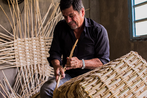 a man is weaving a basket