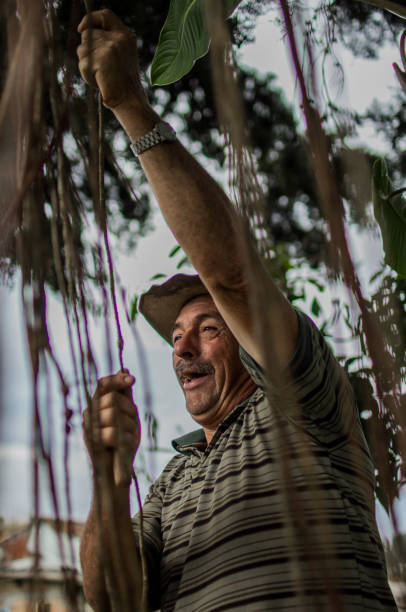 istock portrait of a man working and smiling while handcrafting his materials for the baskets. 1998682985