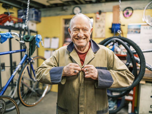 Senior man getting ready to work in his bicycle shop