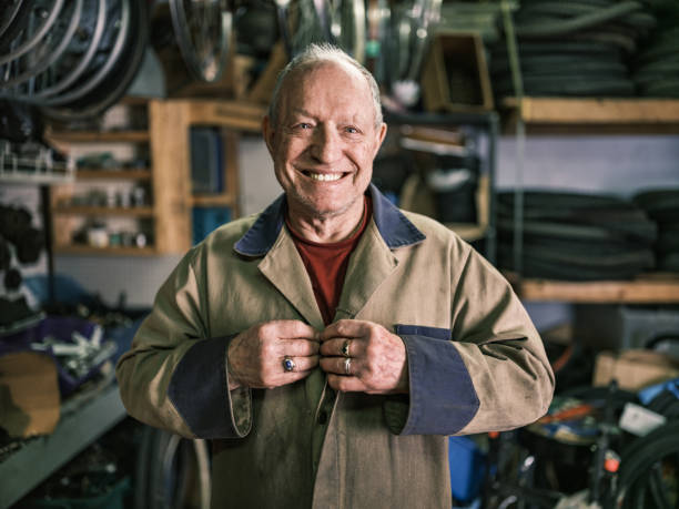 istock Senior man getting ready to work in his bicycle shop 1998700967