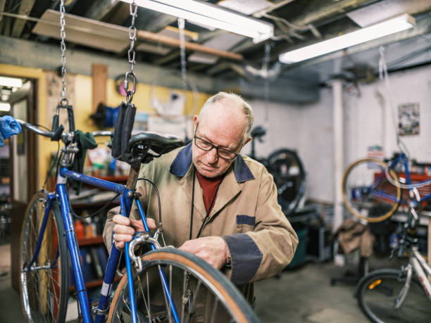 istock Senior man working in his bicycle shop 1998702100
