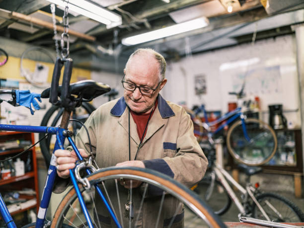 istock Senior man working in his bicycle shop 1998702102