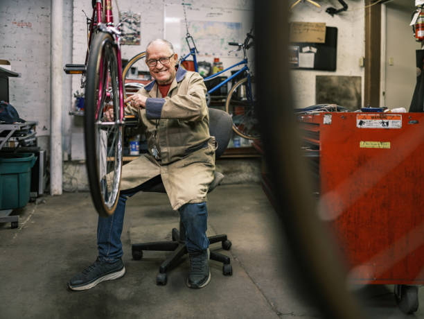 istock Senior man working in his bicycle shop 1998703131