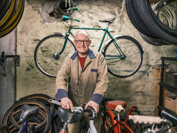 istock Senior man portrait in his bicycle shop 1998703135