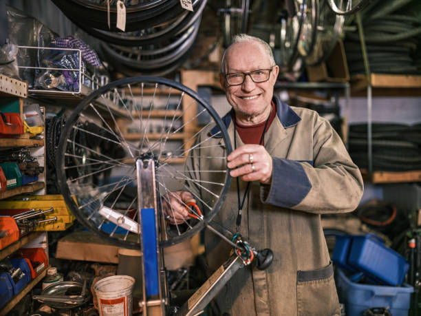 istock Senior man working in his bicycle shop 1998703656