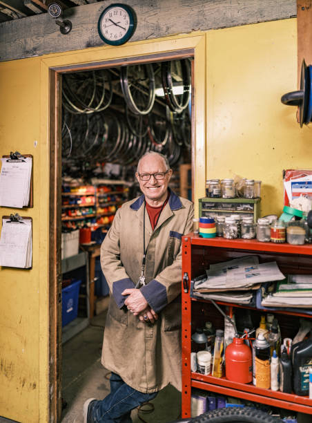 istock Senior man portrait in his bicycle shop 1998704182