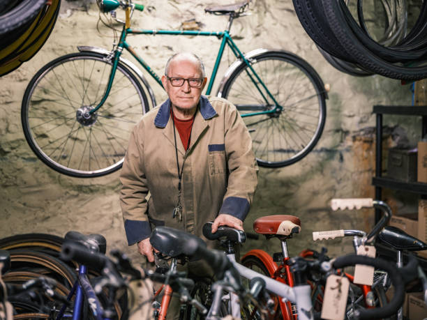 istock Senior man portrait in his bicycle shop 1998704703