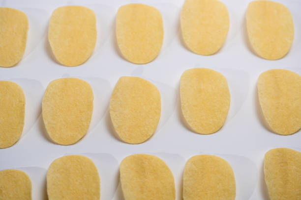 salted potato crisps isolated on white background,Potato chips neatly arranged in lines form the background
