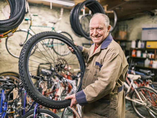 istock Senior man working in his bicycle shop 1998726021