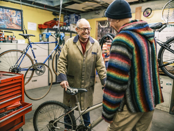 istock Two Senior men talking in bicycle shop 1998727568