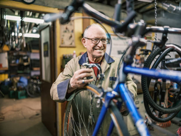 istock Senior man working in his bicycle shop 1998729118