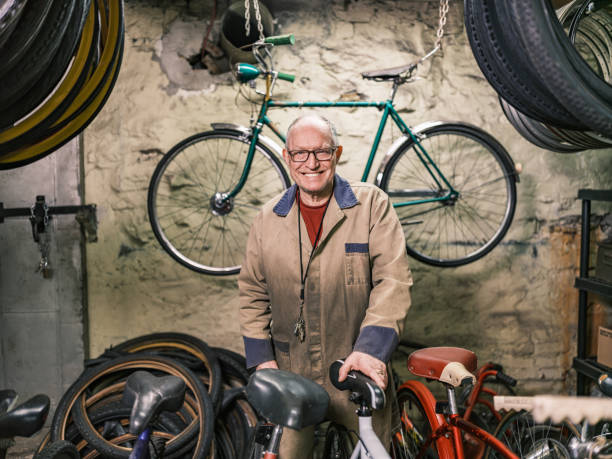 istock Senior man portrait in his bicycle shop 1998729313