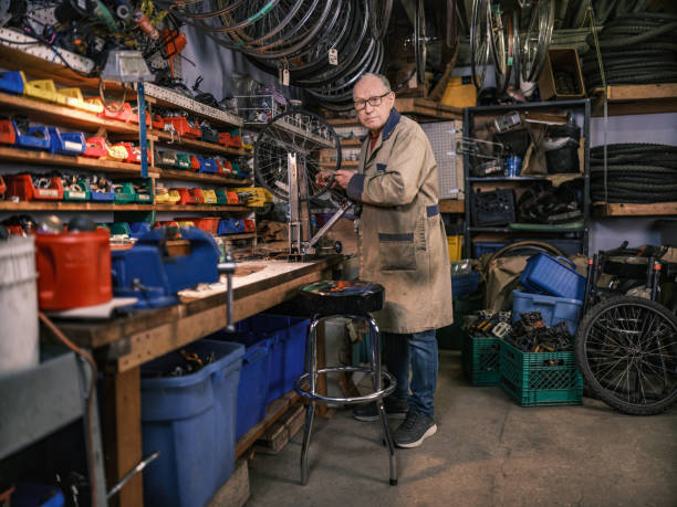 istock Senior man working in his bicycle shop 1998729641