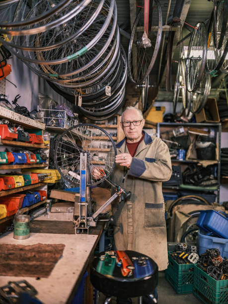 istock Senior man working in his bicycle shop 1998730150