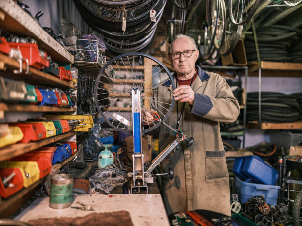 istock Senior man working in his bicycle shop 1998730151