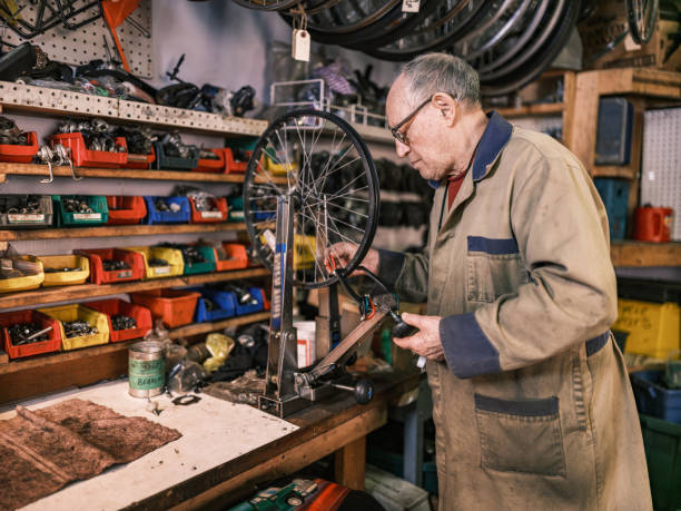 istock Senior man working in his bicycle shop 1998730161