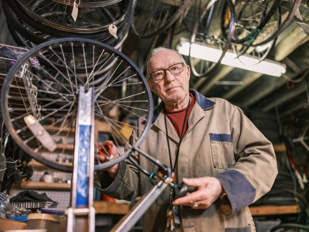 istock Senior man working in his bicycle shop 1998730359
