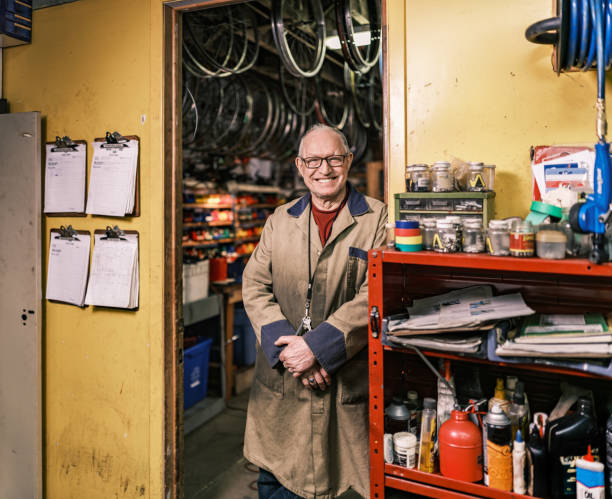 Senior man portrait in his bicycle shop stock photo