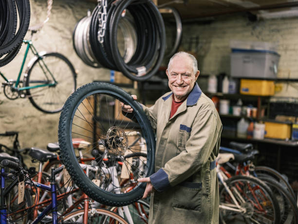 istock Senior man working in his bicycle shop 1998731196