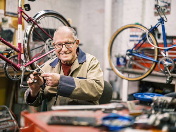 istock Senior man working in his bicycle shop 1998731711