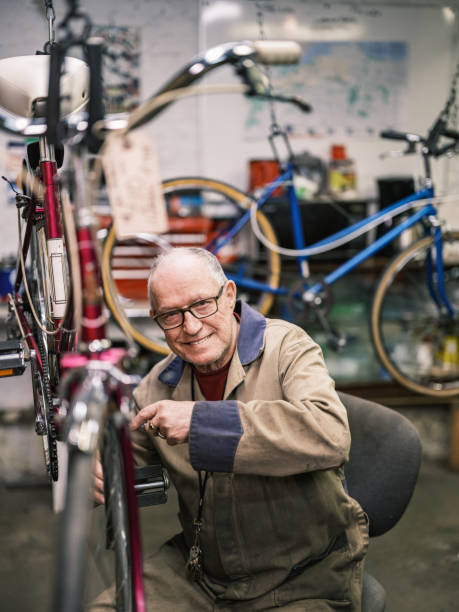 istock Senior man working in his bicycle shop 1998731716