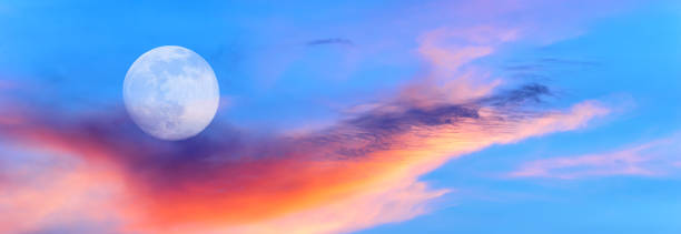 istock Full Moon Sunset Surreal Ethereal Beautiful Colorful Sunrise Sky Header Banner 1998775279