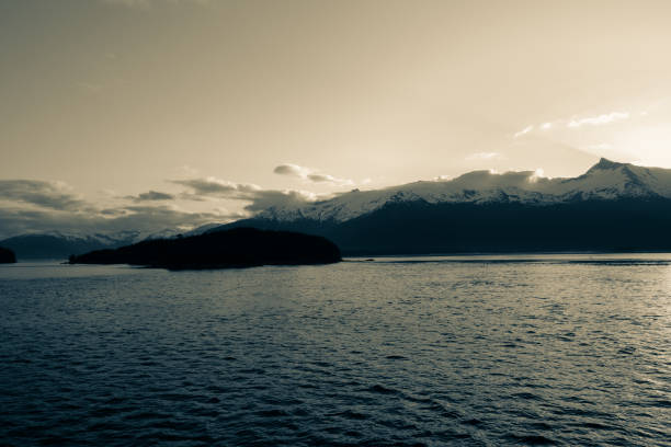 istock Early morning sun rising behind mountains aloing inside passage 1998834074